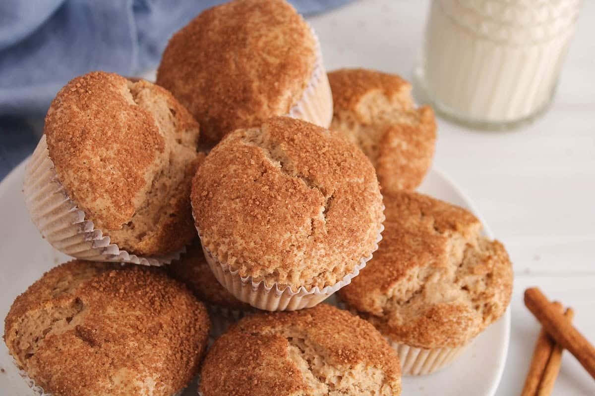 Pile of vegan cinnamon muffins on a plate.