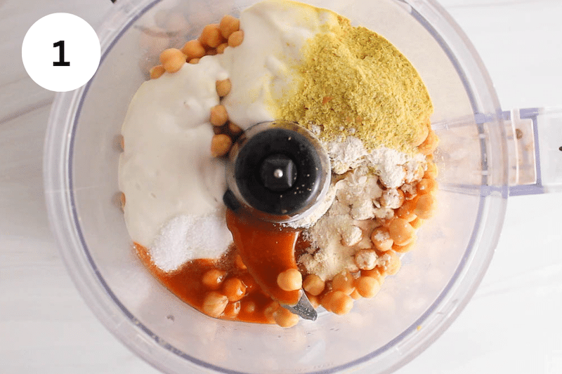 Chickpeas, hot sauce and spices in a food processor.