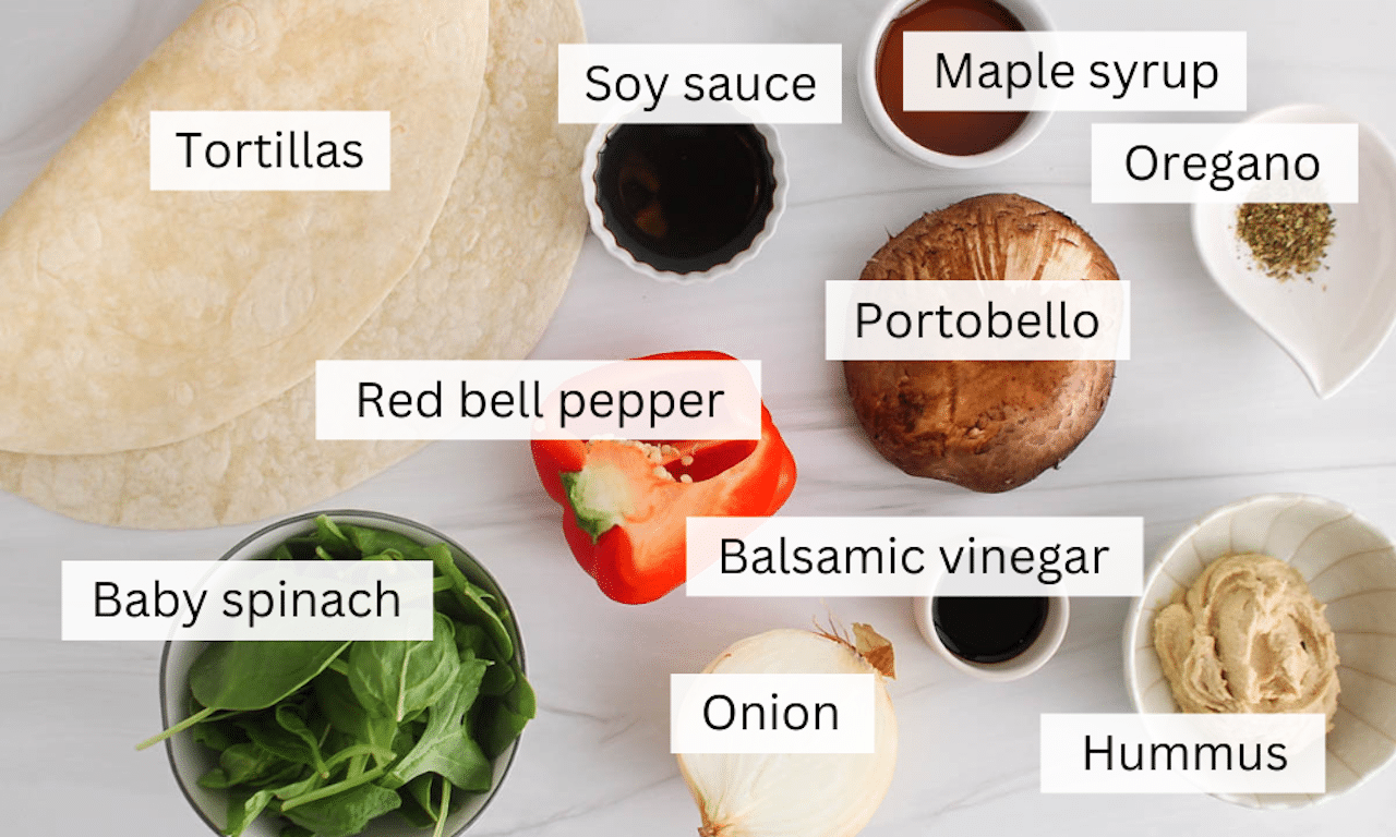 Ingredients to make a healthy portobello mushroom wrap on a white table.