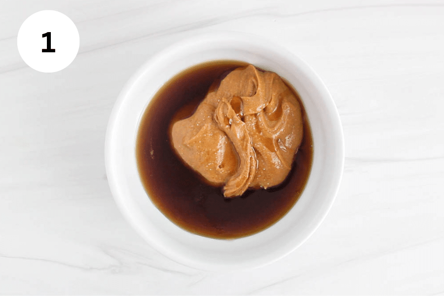 Peanut butter and maple syrup in a white bowl.