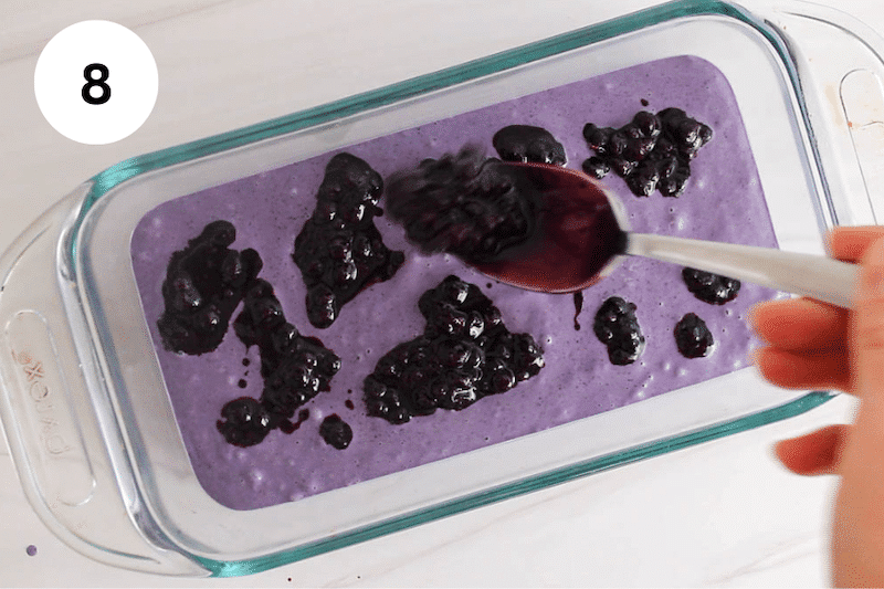 Adding blueberry swirl mix over blueberry ice.