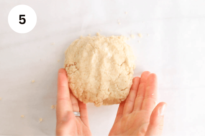 A ball of dough over parchment paper.