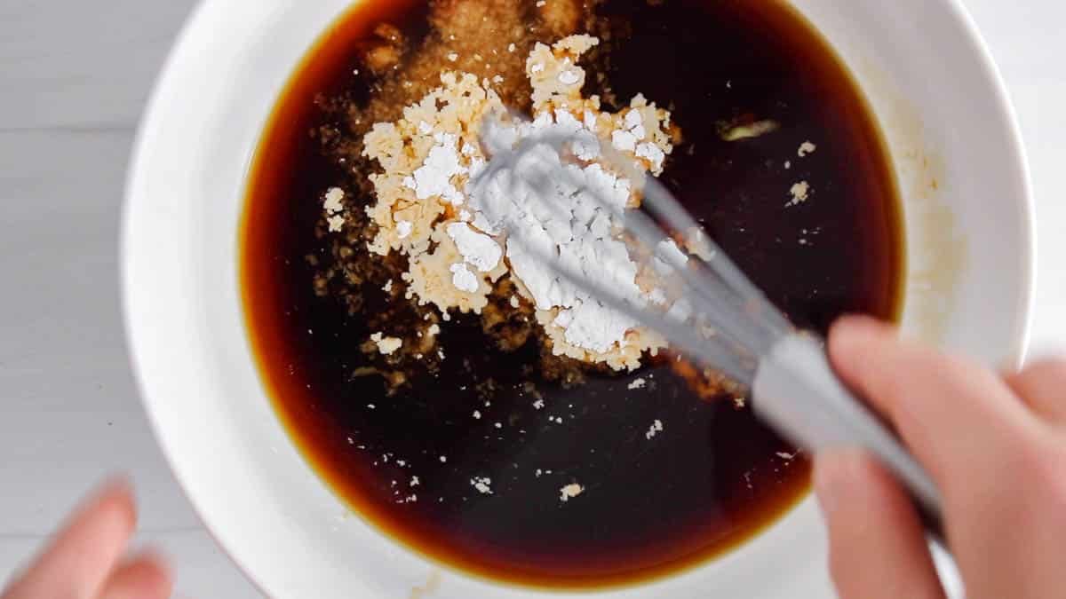 Small bowl with a whisk stirring the teriyaki sauce ingredients.