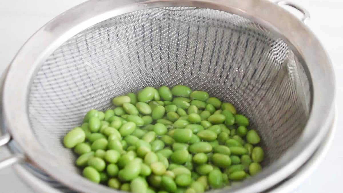 Edamame draining in a colander.