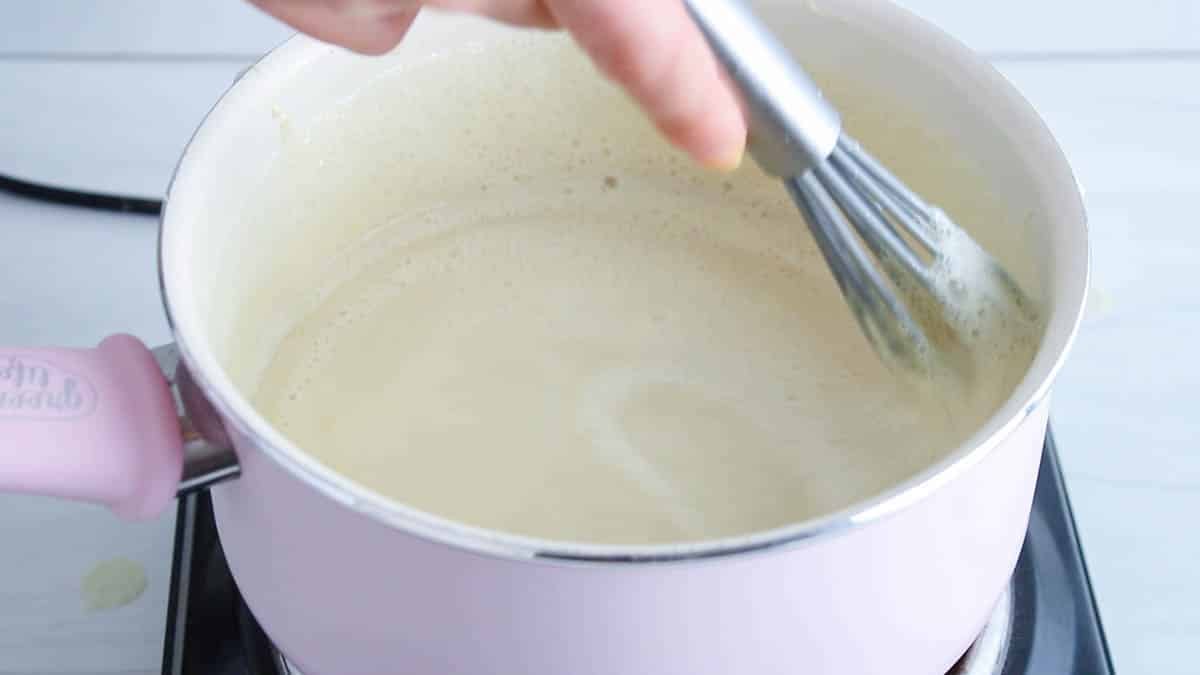 Saucepan warming up a sauce until thickened.