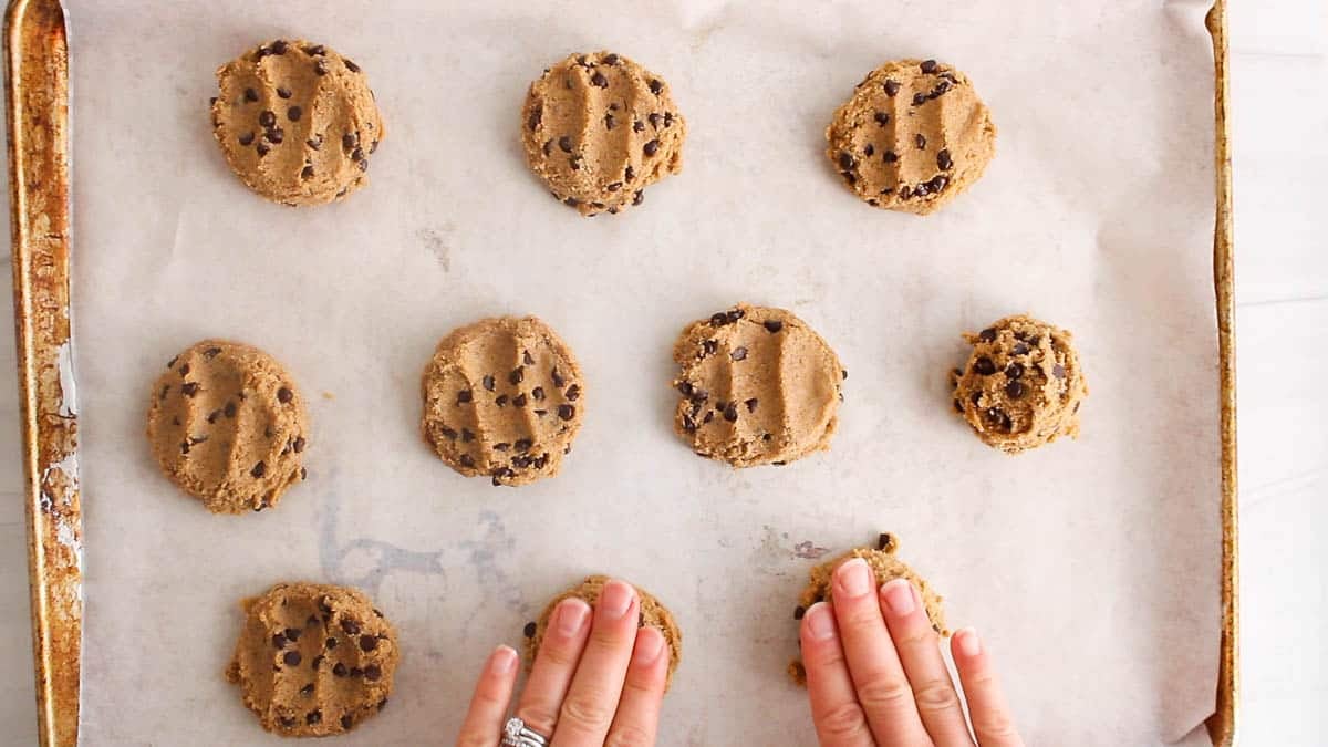 Press on the cookie dough ball to shape them into discs.