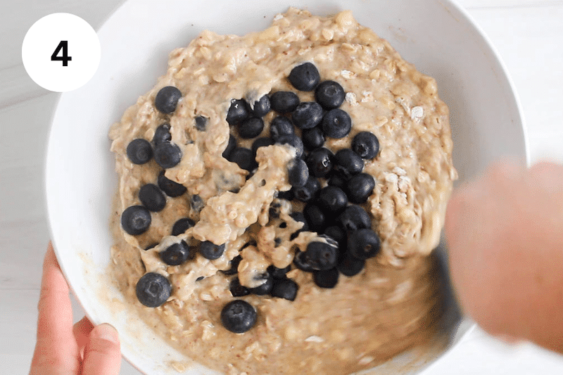 Oatmeal muffin batter topped with fresh blueberries.