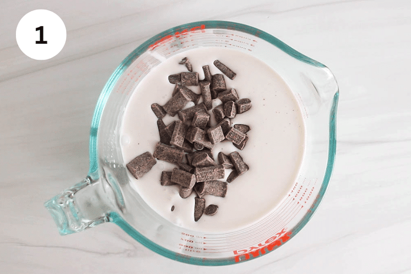 Coconut milk and chocolate chips in a large glass jar.