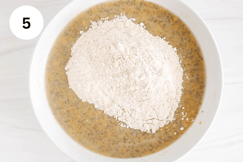 Dry mixture over a wet mixture in a large white bowl.