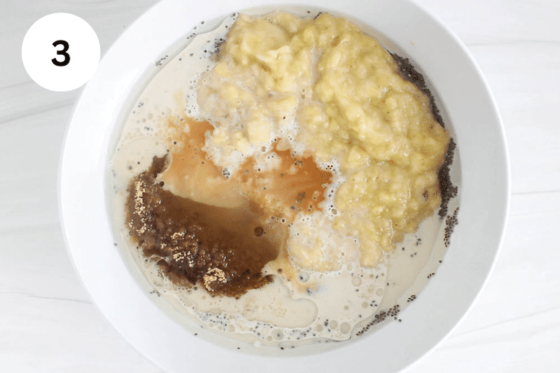 Milk, mashed bananas and sugar in a bowl.