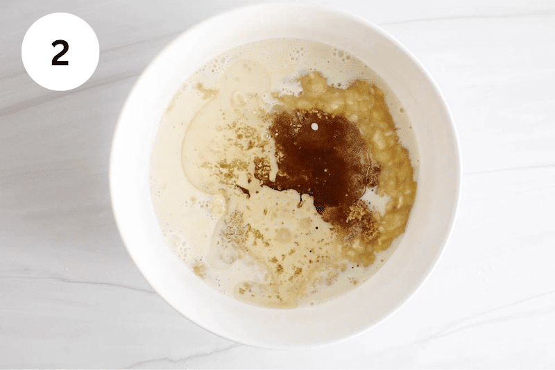 Mashed bananas, oat milk, coconut oil and brown sugar in a medium bowl.