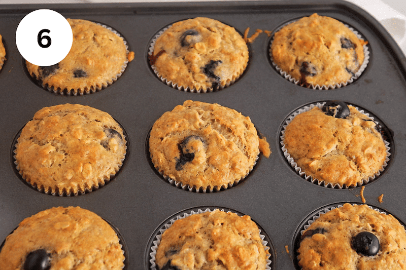 Baked oatmeal blueberry muffins in a muffin pan.