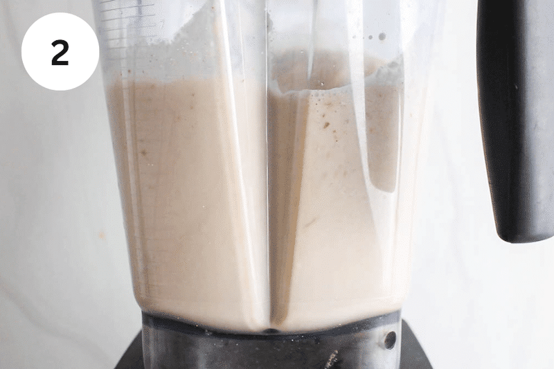 A blender blending a creamy apple mixture.