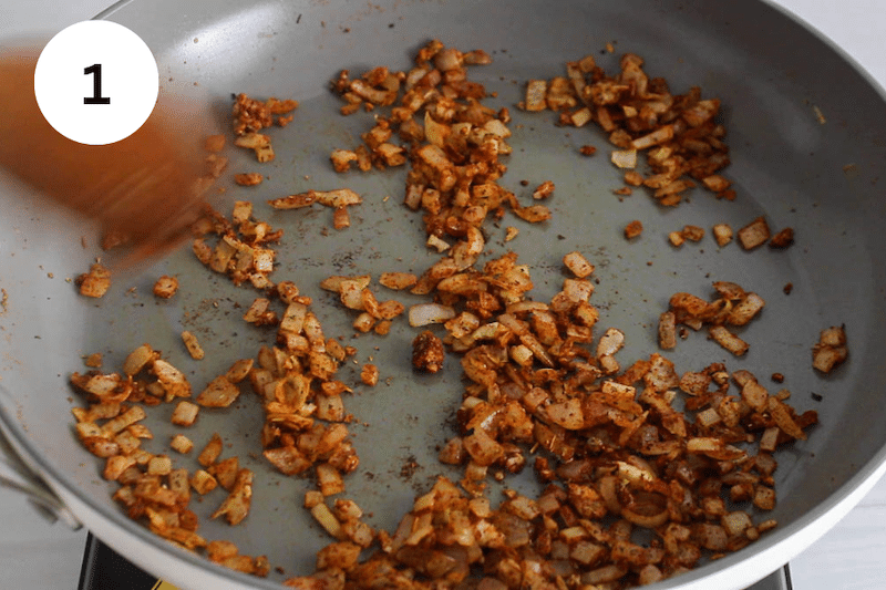 Onion covered with spices in a pan.