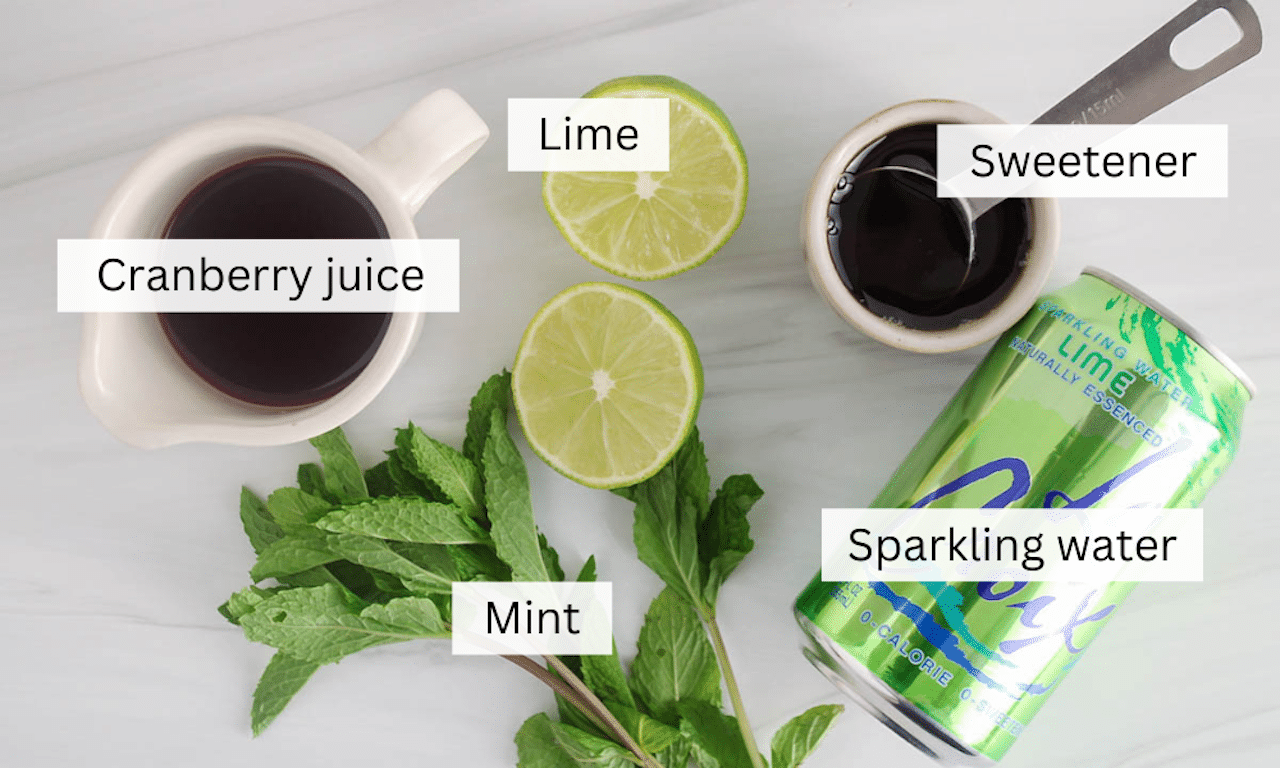 Ingredients to make a cranberry juice mocktail recipe place on a table.