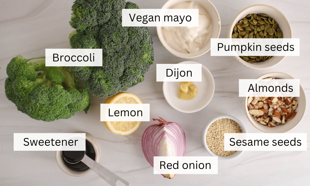 Ingredients needed to make a broccoli crunch salad on a white table.