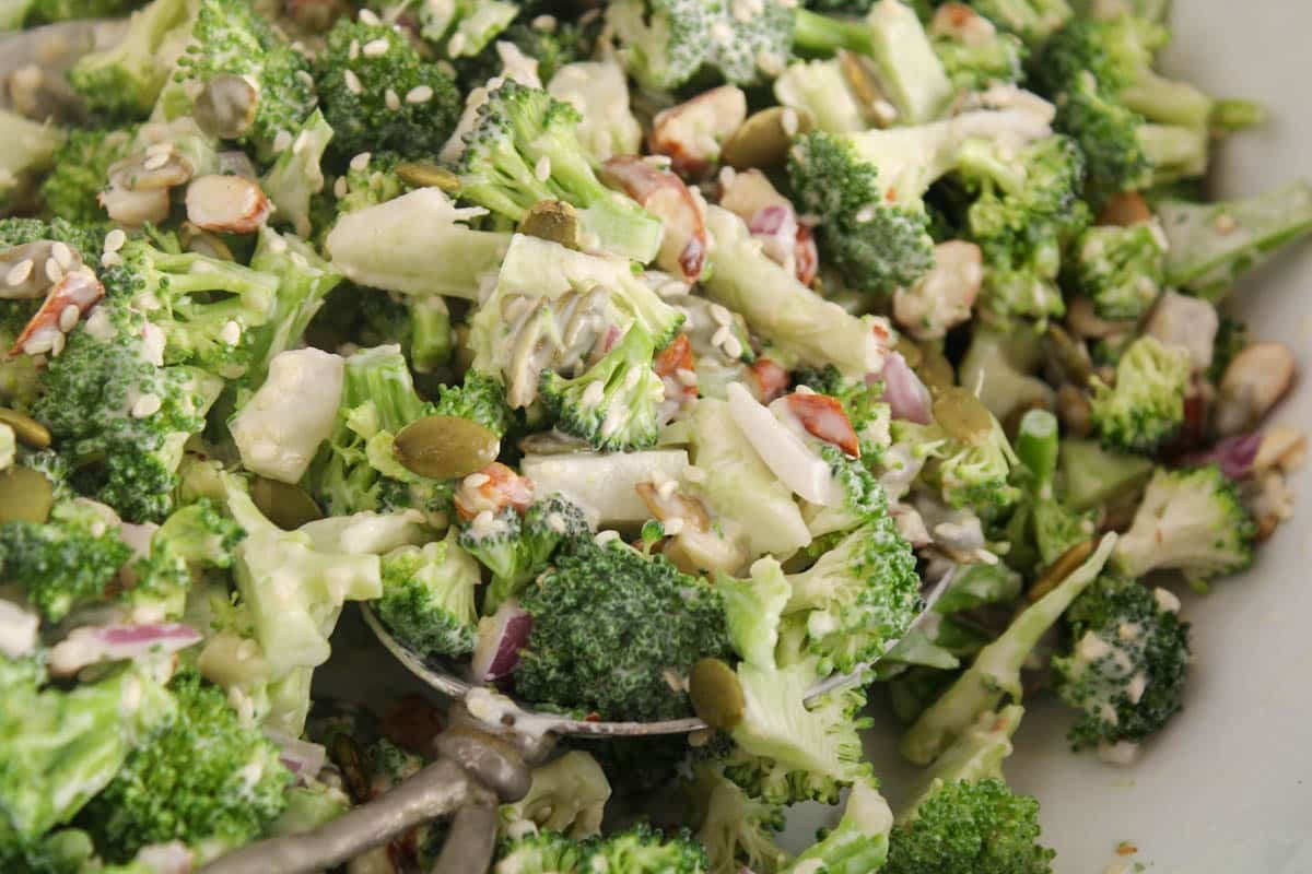 Dairy-free Creamy Broccoli crunch salad with seeds and red onion.