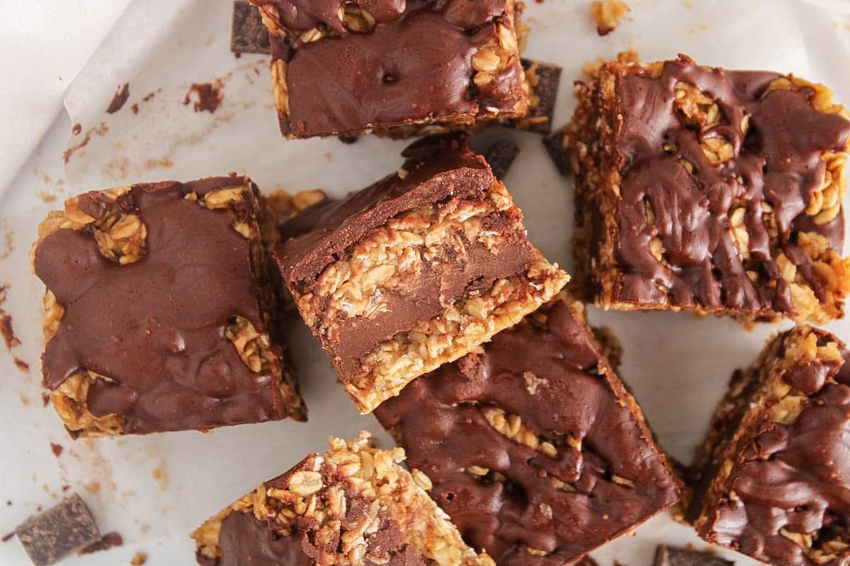 A few bars of no bake chocolate peanut butter oatmeal bars on parchment paper.