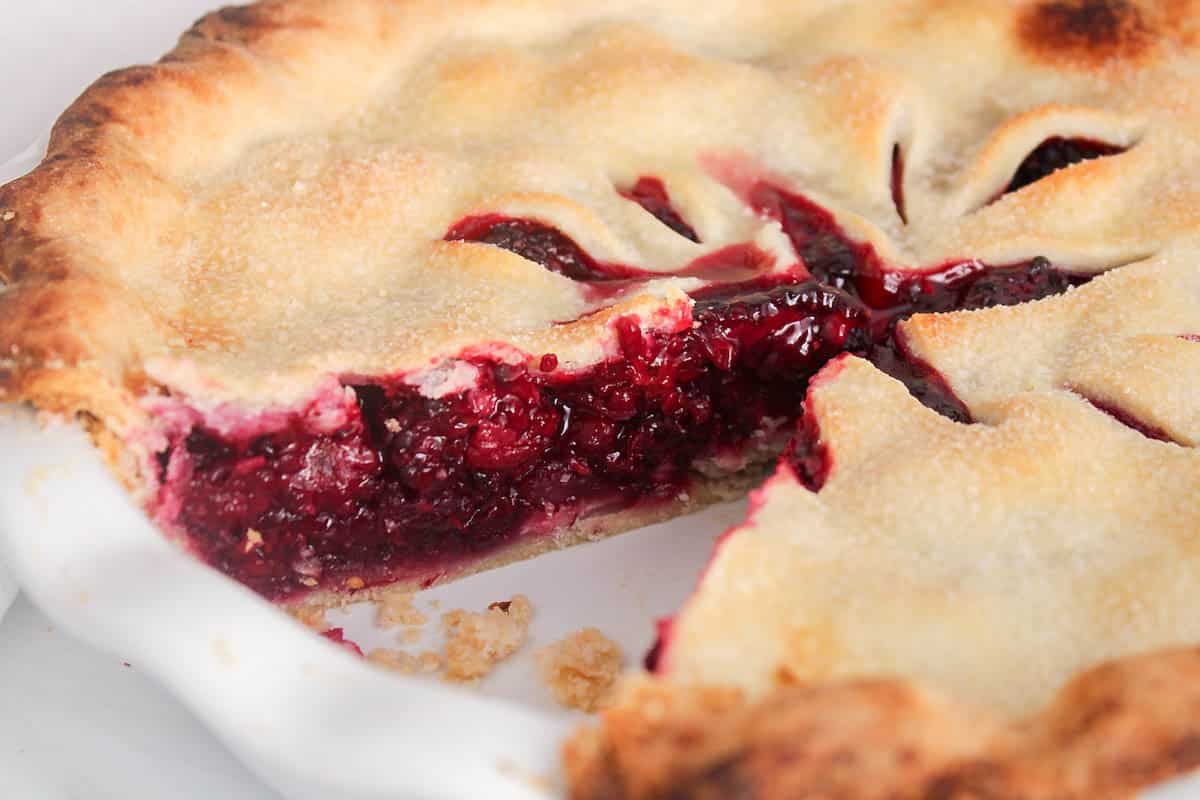 A slice taken off a vegan blackberry pie.