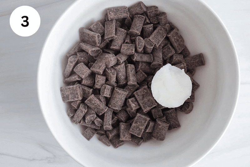 A bowl with chocolate chips and coconut oil.