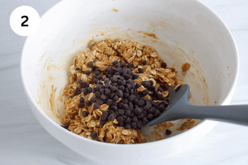 A bowl with a peanut butter oat mixture topped with chocolate chips.