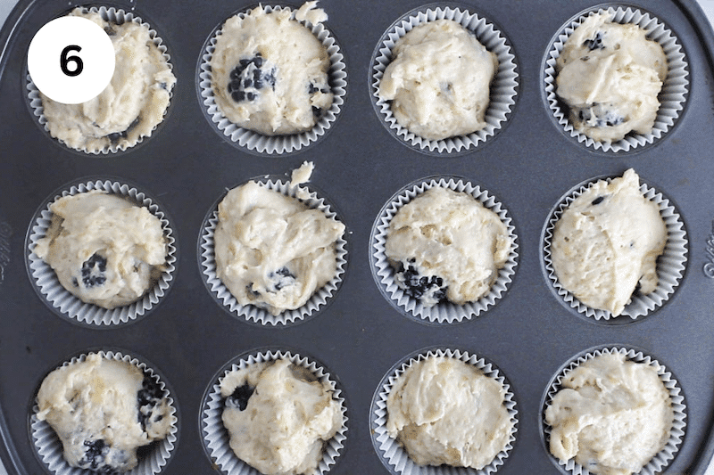 Muffin batter divided into a muffin pan.