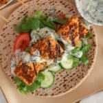 Vegan tofu souvlaki on pita bread with lettuce and tzatziki sauce.
