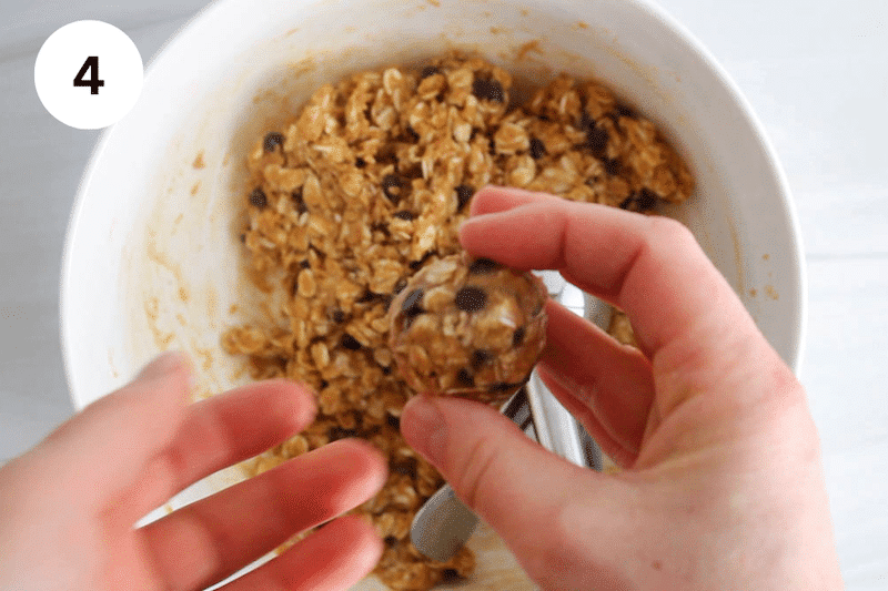 Hands shaping a bliss balls.