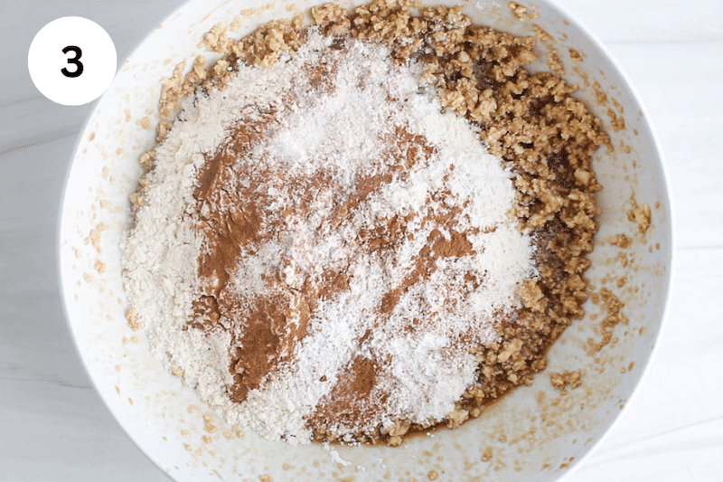 Flour over a buttery wet mix in a large bowl.
