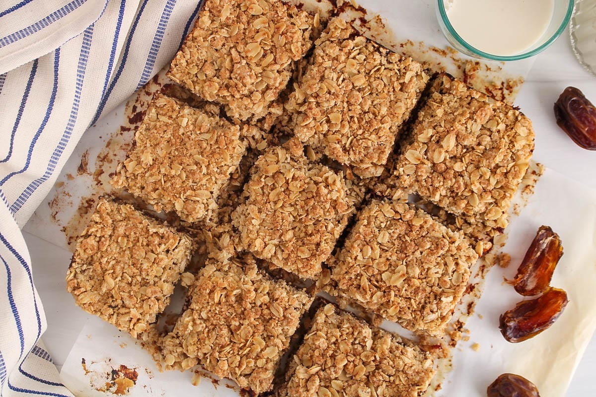 9 vegan date squares on parchment paper.