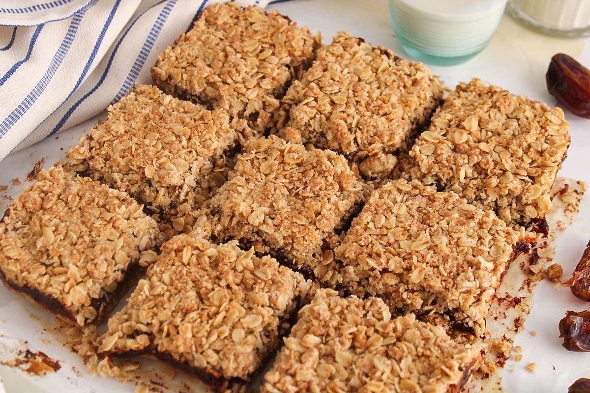 9 vegan date squares on parchment paper.