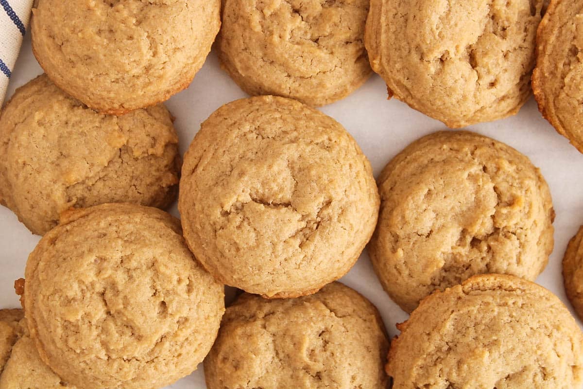 Vegan brown sugar cookies freshly baked on parchment paper.