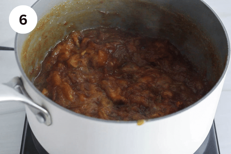 A small sauce pan cooking date with water.