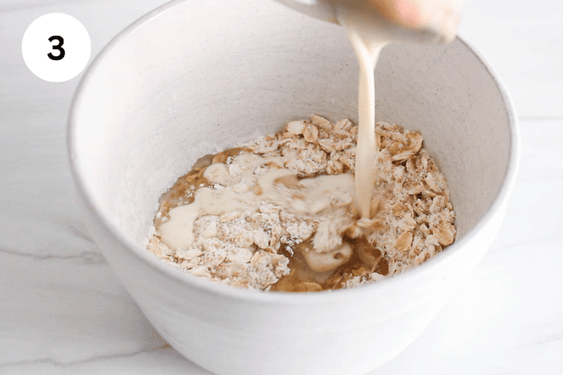 Milk pouring in a bowl with oats and flour.