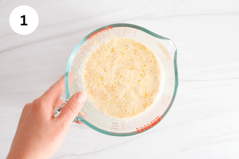 A jar with milk and orange zest.