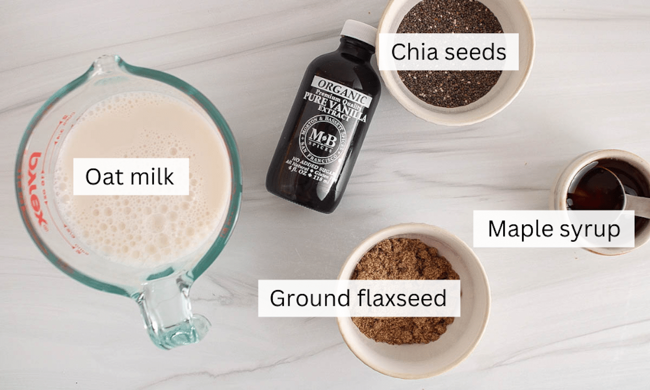 Ingredients to make a chia and flaxseed pudding placed on a white table.