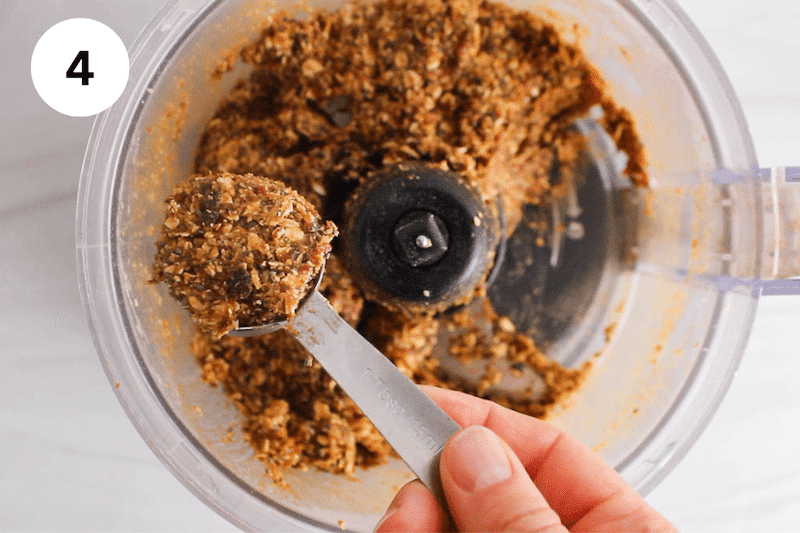 A tablespoon taking some bliss ball mix.