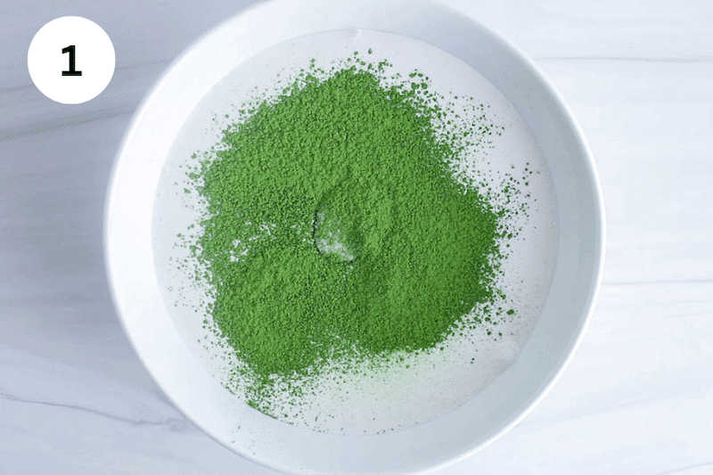 A white bowl with milk and matcha powder.