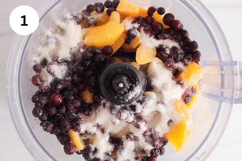 Frozen fruit, sugar and lime juice in a food processor.