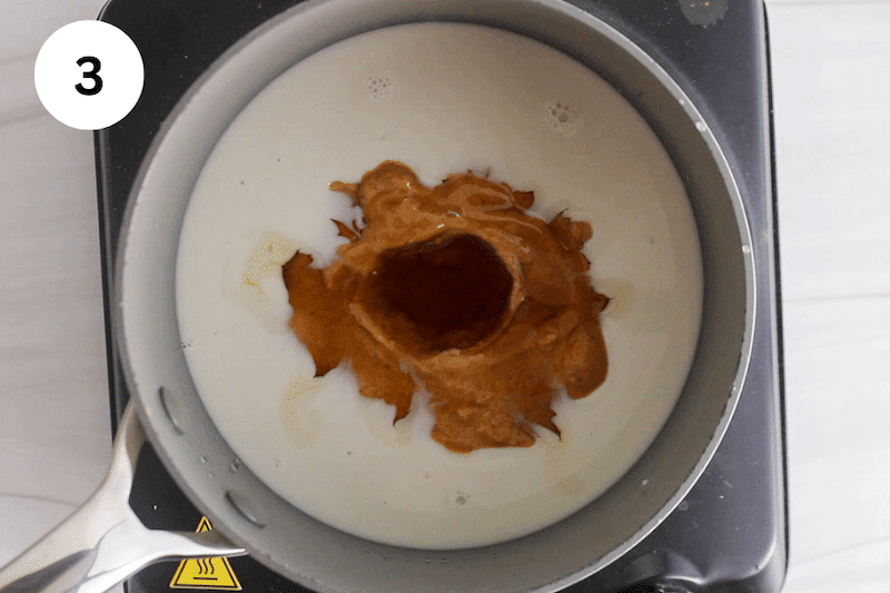 A small pot with milk, peanut butter and maple syrup.