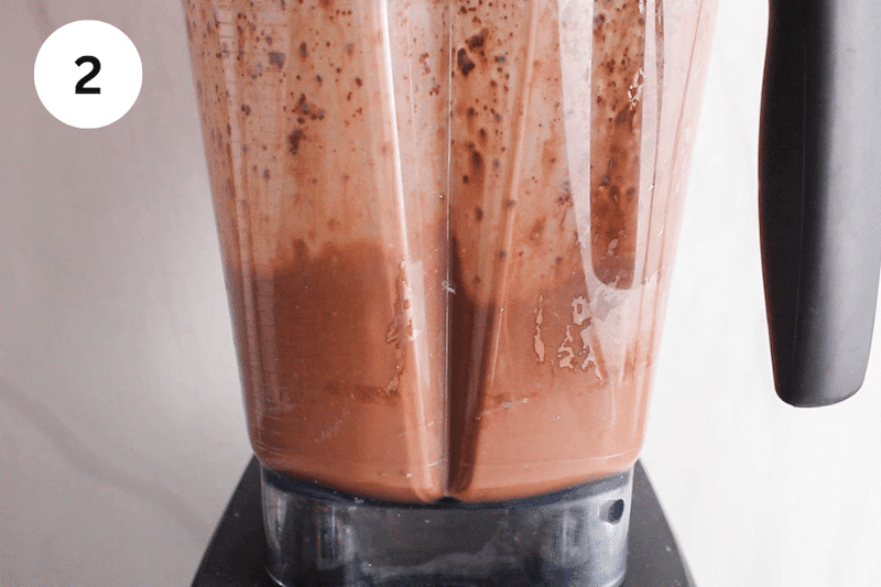 A chocolate pudding blending in a blender.