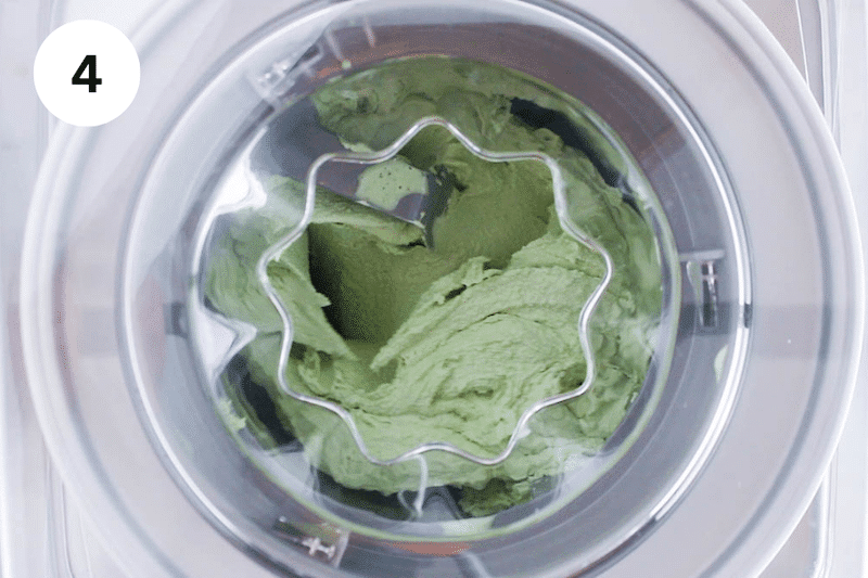 A green tea matcha ice cream churning in an ice cream maker.
