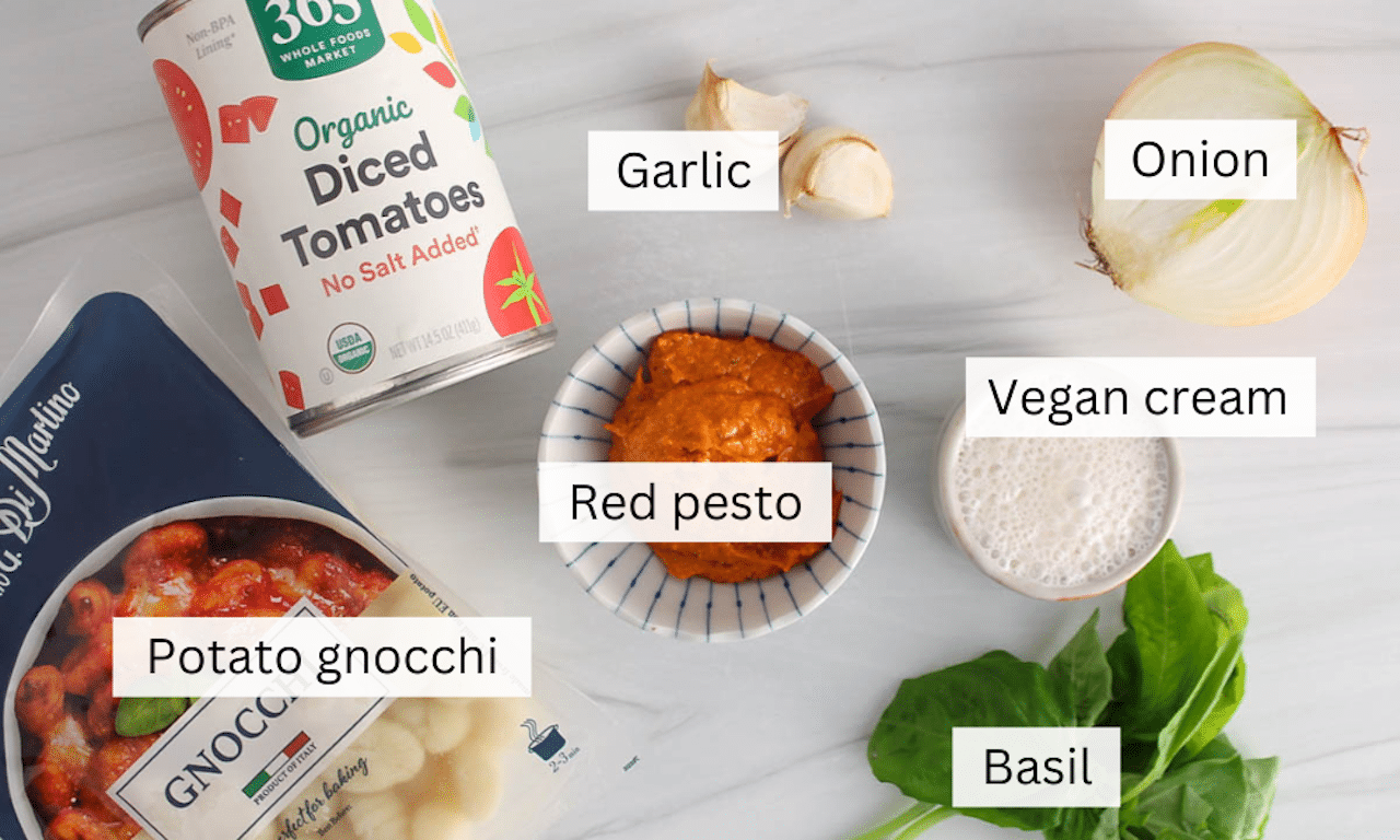 Showing are the ingredients needed to make a vegan red pesto gnocchi.