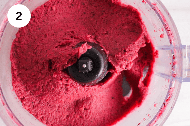 Processed frozen fruit in a food processor.