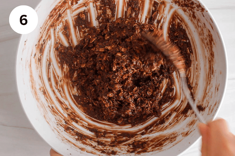 A large white mixing bowl with a chocolate cookie dough.
