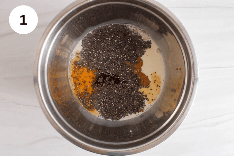 A mixing bowl with wet ingredients topped with chia seeds.