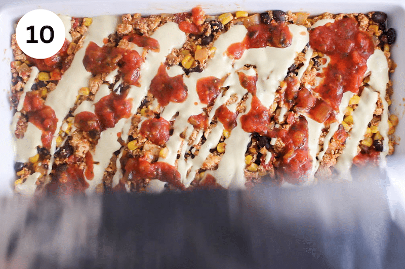 A baking dish being covered with foil.