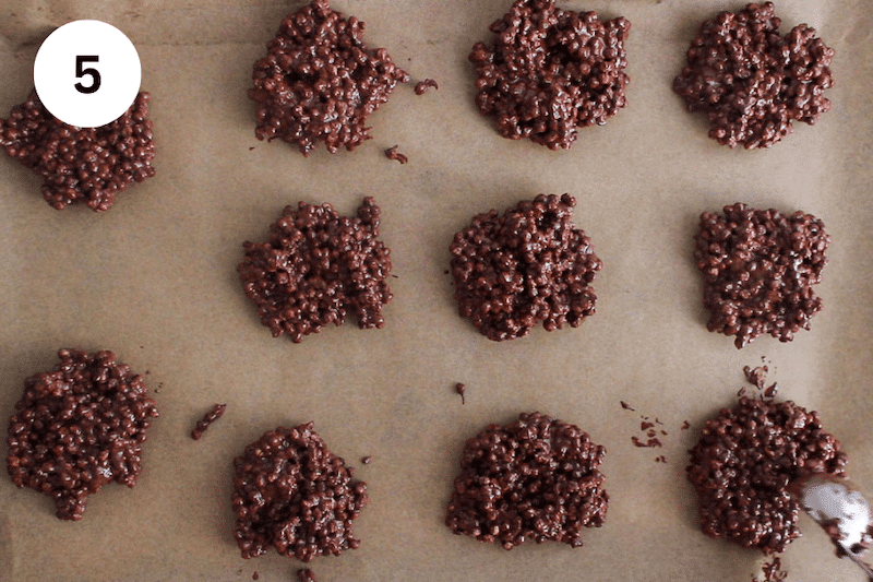 A tablespoon dividing quinoa chocolate bites on a baking sheet.