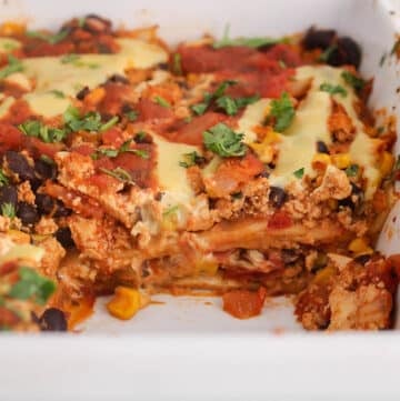 A vegan taco casserole with a portion taken out to show the middle consistency.