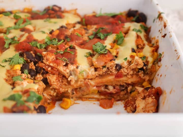 A vegan taco casserole with a portion taken out to show the middle consistency.